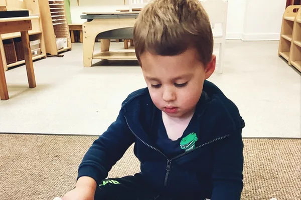 Child with Montessori learning materials at Nurture Childcare