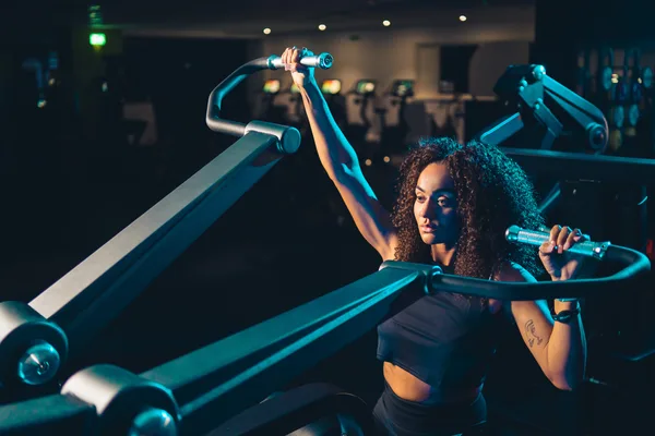 Member training on plate-loaded shoulder press at M Club gym, Stoke-on-Trent