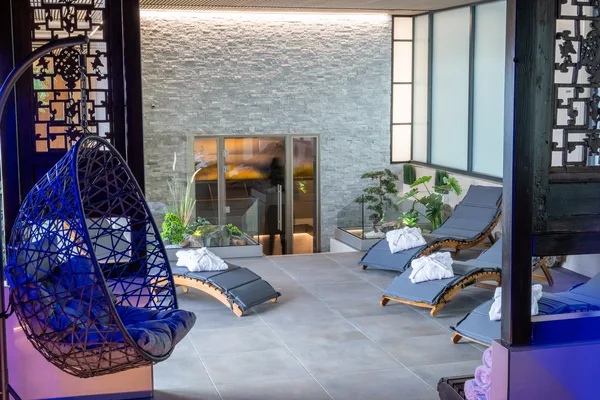 Zen garden with hanging chairs and loungers