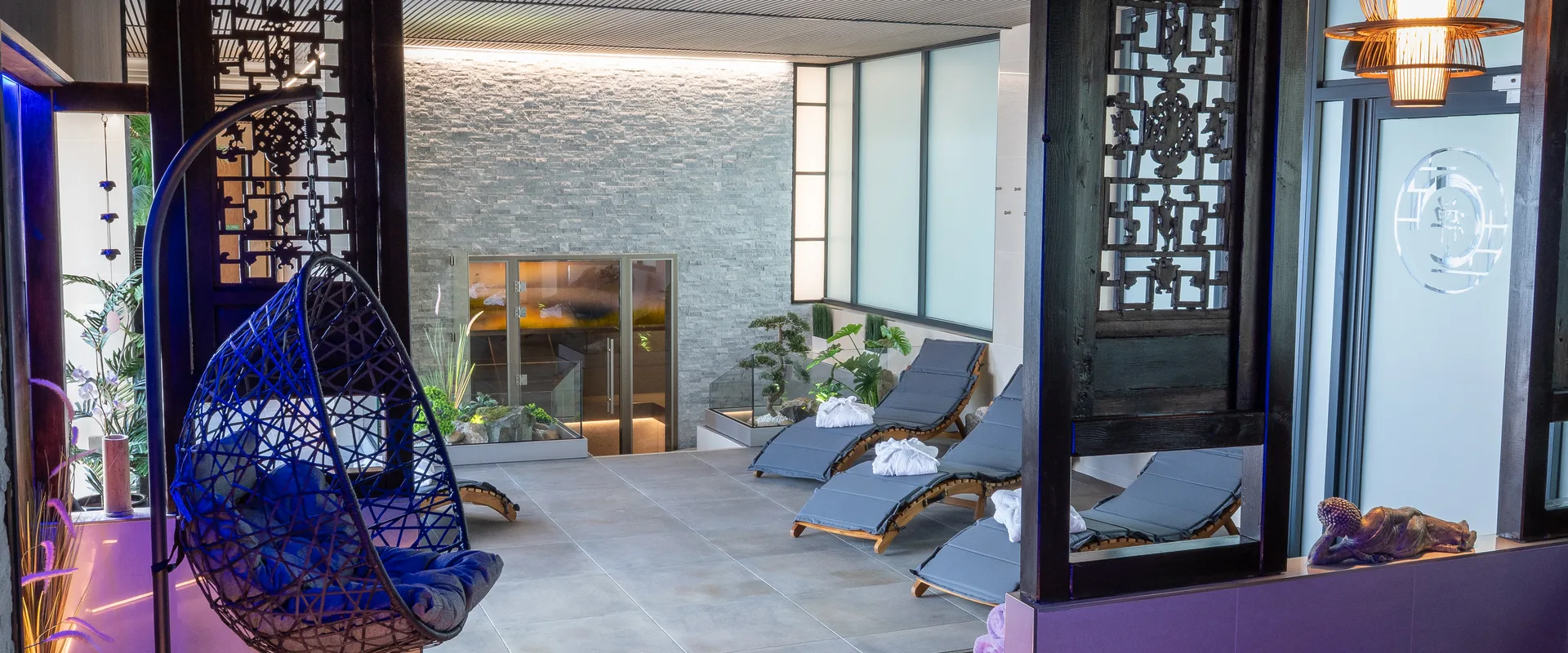 M Club Spa relaxation area with loungers and mood lighting